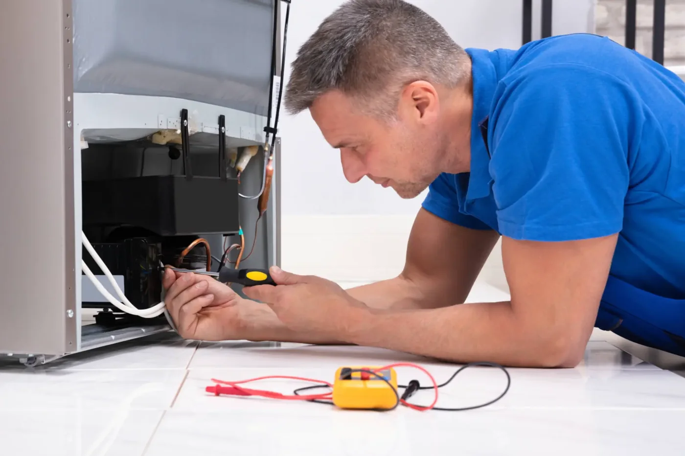 Technician diagnosing a residential freezer cooling system
