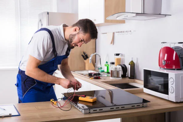 Technician testing a residential electric cooktop